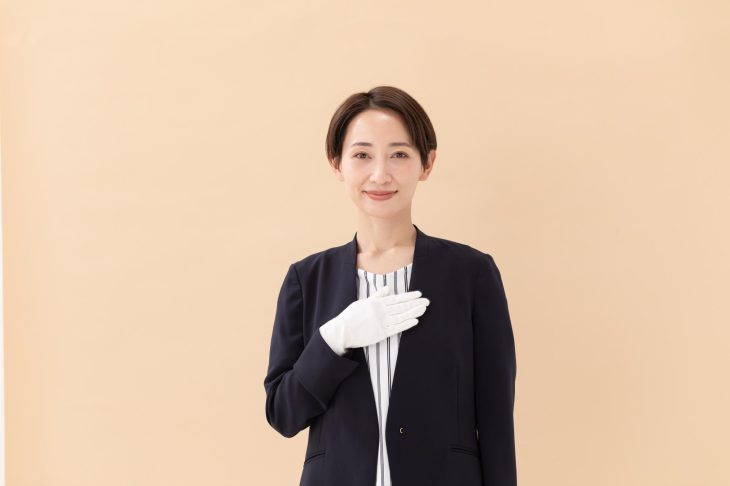胸に手を当てる査定士の女性