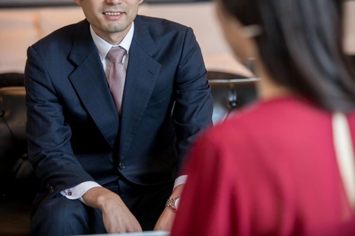 向かい合って座る訪問買取業者と女性